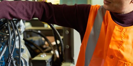worker using digital tablet to control machinery